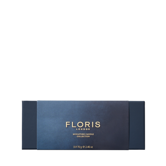 The Floris London Miniature Candle Collection features exquisite miniature scented candles in a dark blue rectangular box with gold text.