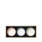 The Floris London Miniature Candle Collection features three scented candles in round containers, arranged in a rectangular black and gold box, top view.