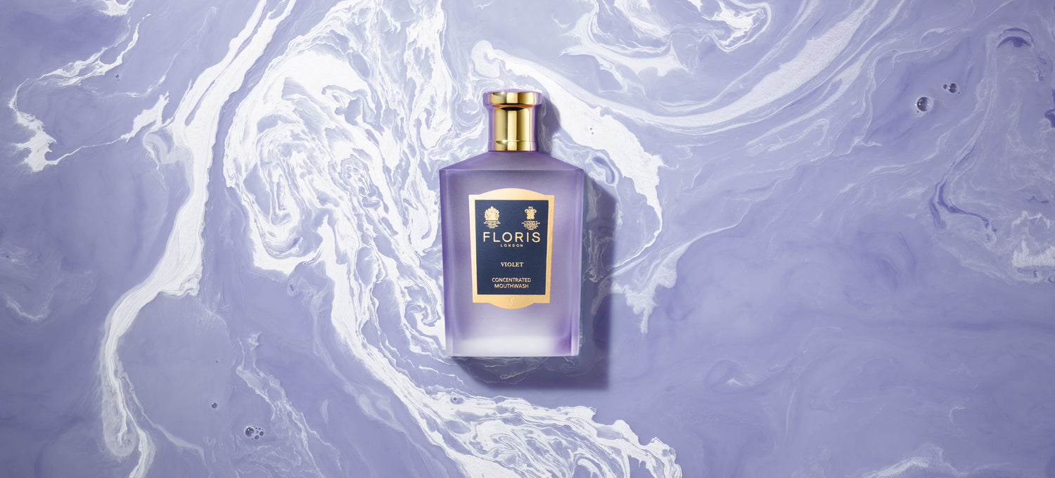 Bottle of Violet Floris London Mouthwash on a Purple and White swirled background