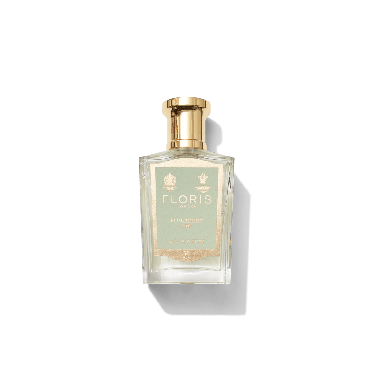 A bottle of Floris London Mulberry Fig Eau de Parfum, adorned with a gold cap and label, captures the essence of London's oldest Royal Parks against a white background.