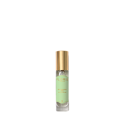 A small glass perfume bottle with a gold cap and a light green Floris London label, featuring Mulberry Fig - Eau de Parfum with a woody scent.