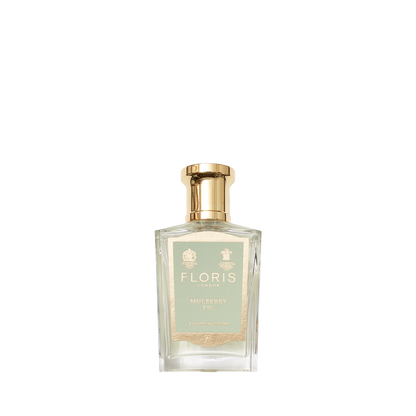 Clear glass Floris London Mulberry Fig - Eau de Parfum bottle with a gold cap and pale green label, featuring a soft, elegant woody scent.