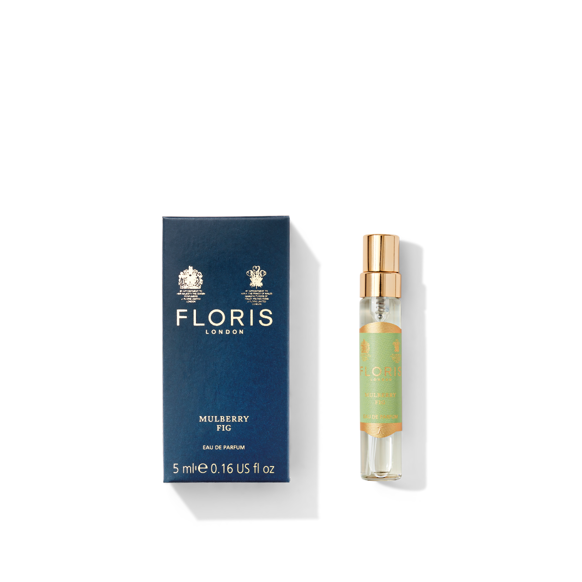 A blue box from Floris London UK is placed next to a small Mulberry Fig Eau de Parfum 5ml bottle, featuring a gold cap and offering a floral amber scent with a delicate woody undertone.