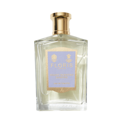 A clear glass bottle of Floris London Night Scented Jasmine Eau de Toilette, featuring notes of white jasmine and neroli blossom, topped with a gold cap.