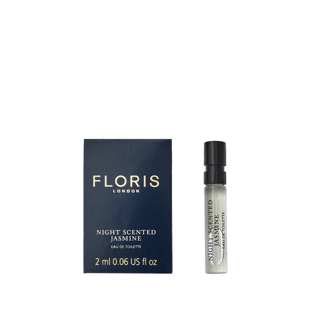 A sample vial of Floris London Night Scented Jasmine Eau de Toilette, featuring white jasmine and neroli blossom, lies next to its dark blue box.
