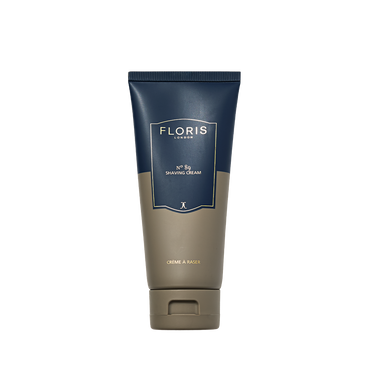 A 100ml tube of Floris London No. 89 Shaving Cream stands upright, featuring a blue and beige design.