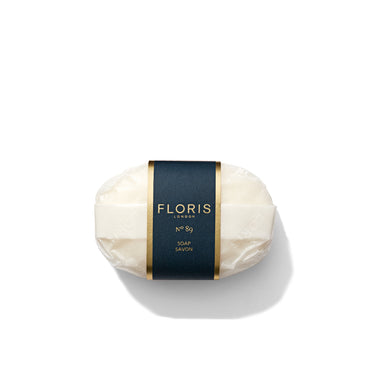 A bar of Floris London's No. 89 Luxury Soap, elegantly packaged with a dark blue and gold label, encased in clear wrapping.