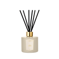 A Floris London Oud & Cashmere reed diffuser in beige with a gold cap and black reeds, shown on a plain white background.