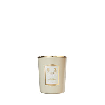 The Floris London Oud & Cashmere Scented Candle, in a gold-trimmed glass jar, adds a touch of luxury fragrance to any room.