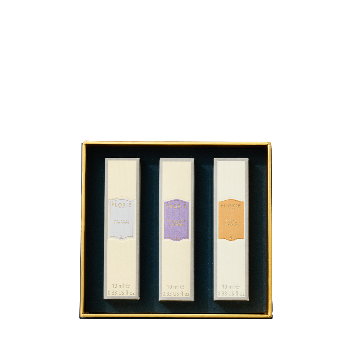 Floris London US Perfumer's Trilogy: For Her—three rectangular perfumes in a gold-edged box, each with a unique pastel label.