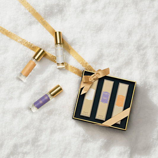 The Perfumer's Trilogy: For Her gift box by Floris London US features three perfume bottles and three vials, beautifully set on snow with gold ribbon.
