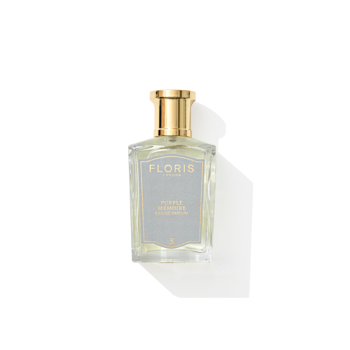 The Purple Mémoire perfume bottle by Floris London, with a gold cap and English charm, sits elegantly on a white background.