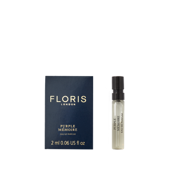 A 2ml Floris London Purple Mémoire - Eau de Parfum vial rests beside its dark blue box—a refined scent evoking classic English elegance.