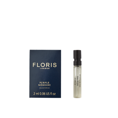 A 2ml Floris London Purple Mémoire - Eau de Parfum vial rests beside its dark blue box—a refined scent evoking classic English elegance.