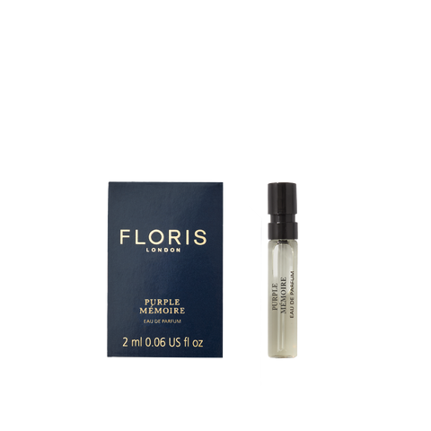 A 2ml Floris London Purple Mémoire - Eau de Parfum vial rests beside its dark blue box—a refined scent evoking classic English elegance.
