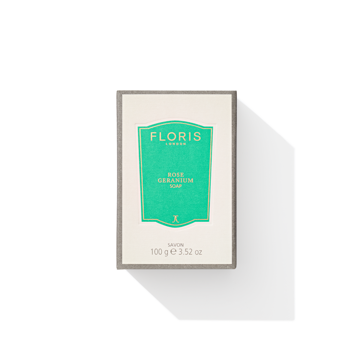 A box of Floris London Rose Geranium - Luxury Soap, adorned with a green label and offering a delicate floral scent, casts a shadow on a pristine white background.