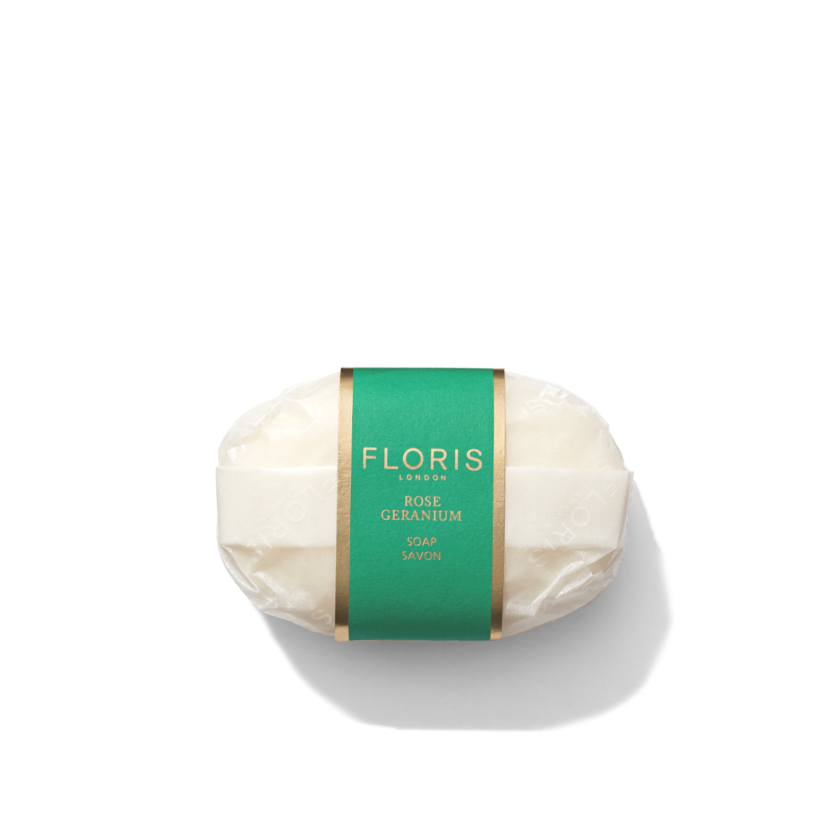 A bar of Floris London's Rose Geranium Luxury Soap, offering a delightful floral aroma, is elegantly wrapped in green packaging and displayed on a pristine white background.