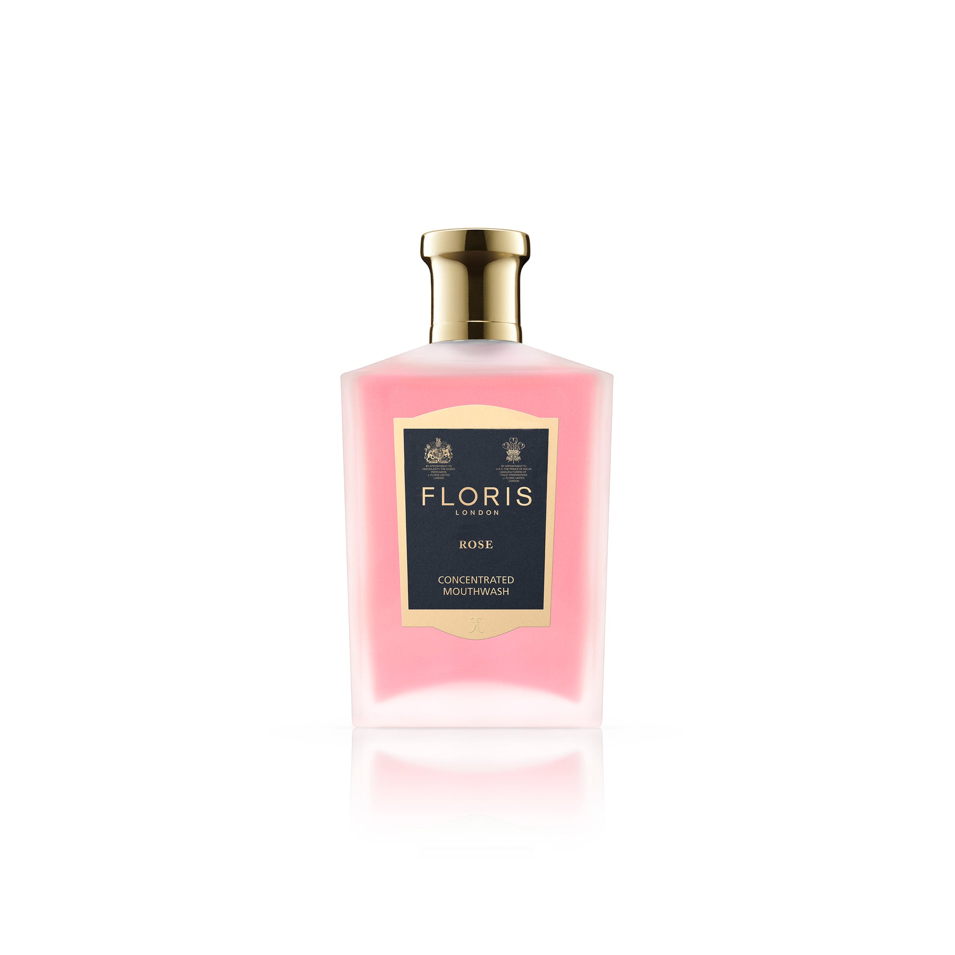 A bottle of Floris London Rose Mouthwash showcases a pink floral-flavored liquid complemented by a gold cap.