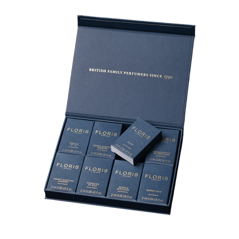 A blue Floris London UK Sample Set box contains eight neatly arranged 2ml fragrance bottles.