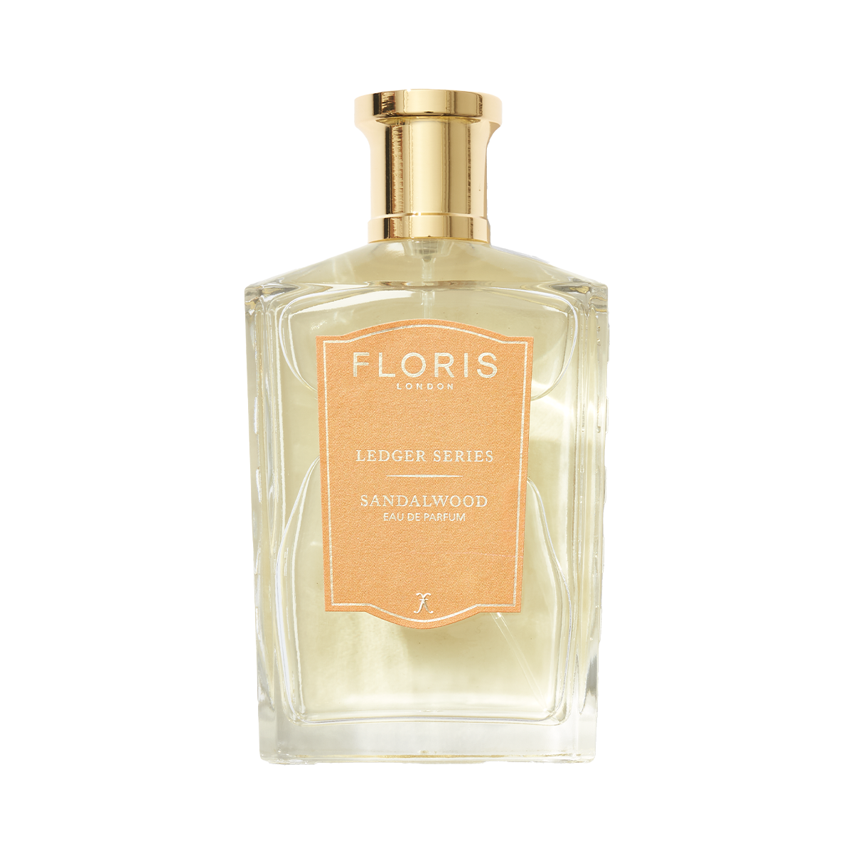 Clear perfume bottle labeled "Floris London UK, Sandalwood," featuring sandalwood oil with a gold cap and light brown label.