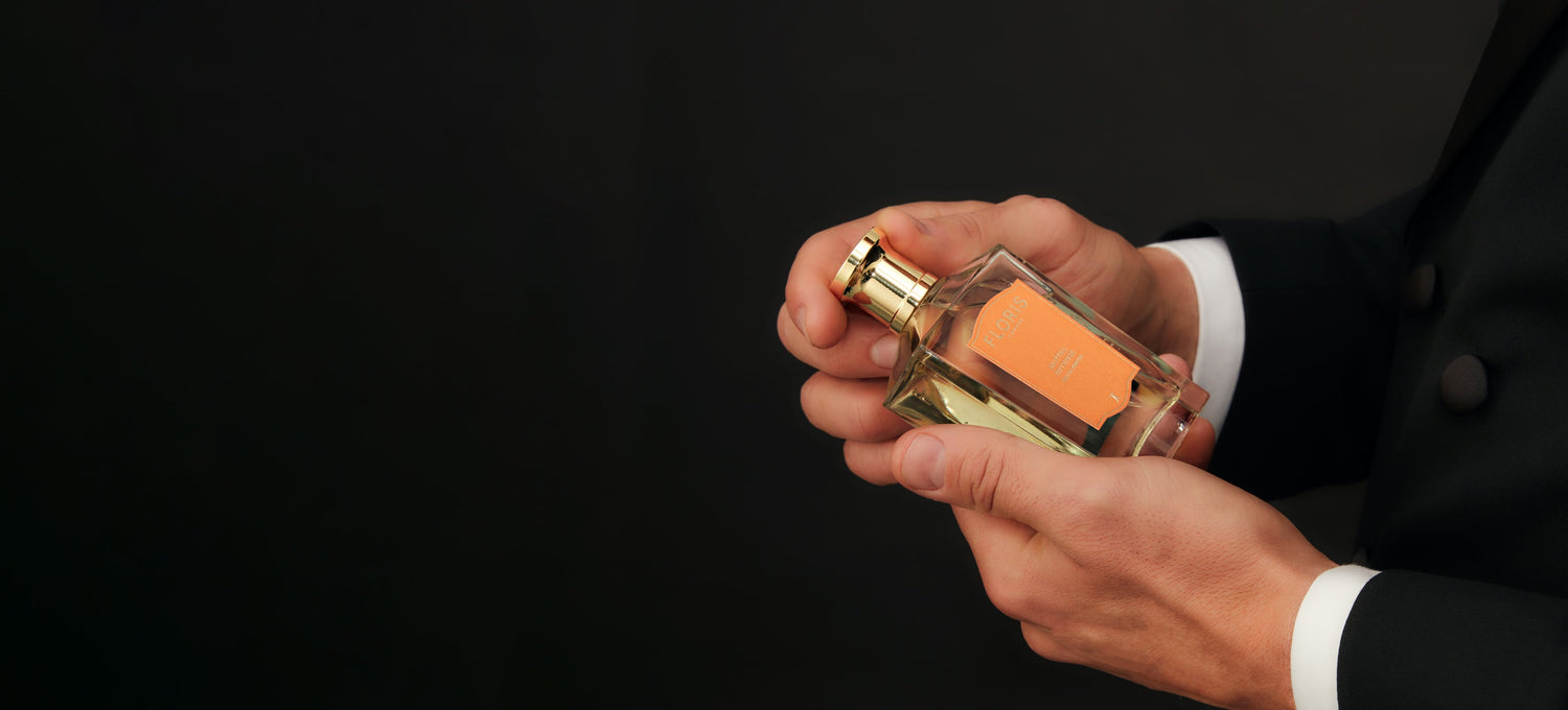 Promotional display for Santal Intense by Floris London US, holding the luxurious perfume bottle against a dark background.