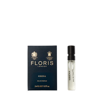 A small vial of Floris London Sirena - Eau de Parfum sits beside its dark blue and gold box, highlighting its fresh floral fragrance.