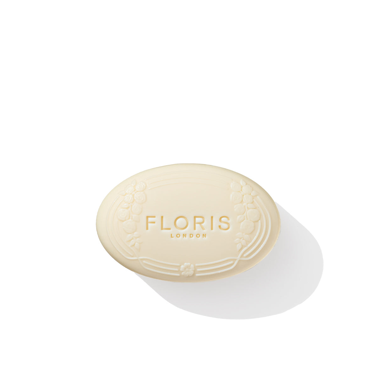 The Rose Geranium - Luxury Soap from Floris London is an elegant oval bar adorned with embossed text of "FLORIS LONDON" and a decorative floral design, reflecting its delicate Rose Geranium essence, all on a pristine white background.