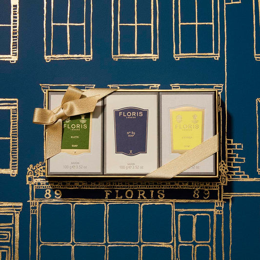 Three Floris London US Soap Collection | For Him gift boxes with gentlemen's fragrances and shea butter, set against a blue and gold background.