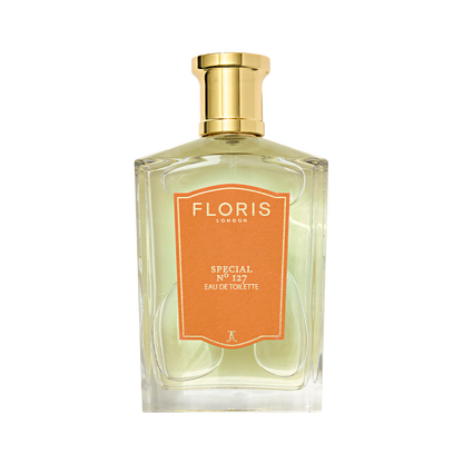 A clear glass bottle of Floris London Special No. 127 Eau de Toilette with a gold cap and orange label.