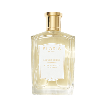 A clear glass bottle of Floris London Stephanotis with a gold cap, white label, and a fresh green floral fragrance of stephanotis blossom.