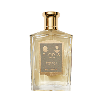 A clear glass bottle of Floris London Tuberose In Silk Eau de Parfum with a gold cap—a truly elegant, floral scent.