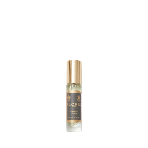 A small glass perfume bottle with a gold cap and a dark label reads "Tuberose In Silk by Floris London," perfect for fans of jasmine scents.