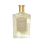 A clear glass bottle of Floris London Vetiver Eau de Parfum features a gold cap and beige label, capturing a grounding, earthy scent.