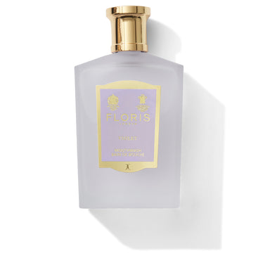 Frosted perfume bottle with gold cap and purple label reading "Violet - Mouthwash" by Floris London, for luxurious dental hygiene.