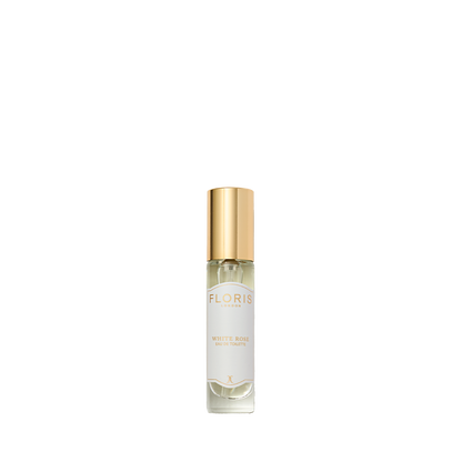 Clear glass bottle with gold cap labeled "White Rose - Eau de Toilette" by Floris London, a timeless vegan perfume, shown on a white background.