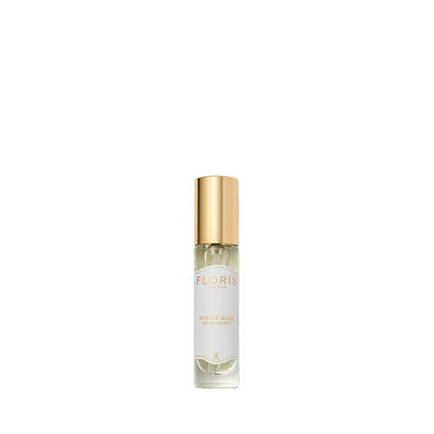 Clear glass bottle with gold cap labeled "White Rose - Eau de Toilette" by Floris London, a timeless vegan perfume, shown on a white background.