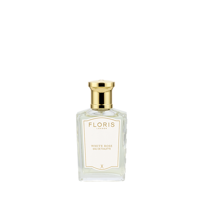 A clear glass bottle of Floris London White Rose - Eau de Toilette vegan perfume with a gold cap, shown on a white background.