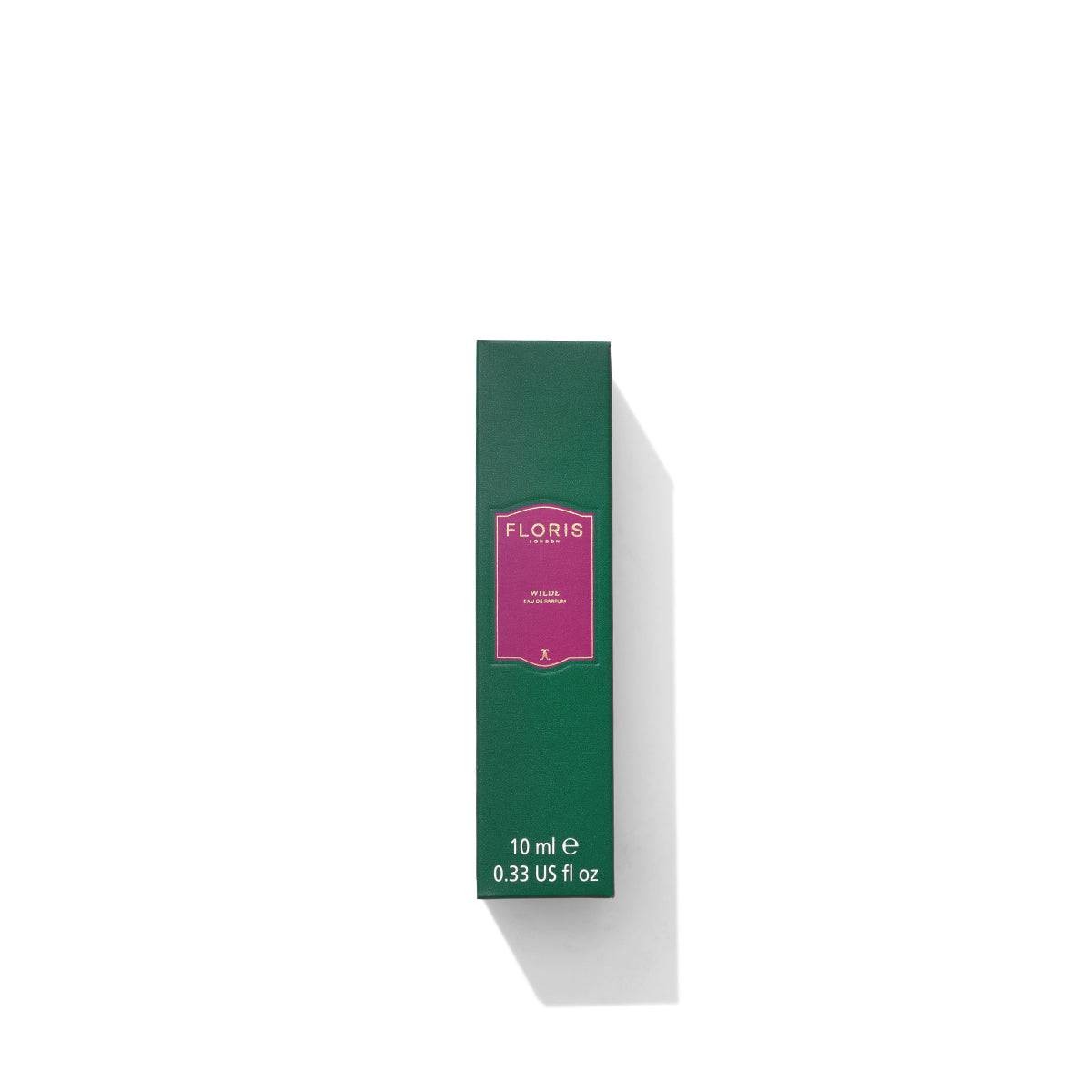 Green and pink rectangular perfume box on a white background, labeled "Floris London." Named Wilde - Eau de Parfum, this 10 ml or 0.33 US fl oz fragrance captures the essence of freedom and individuality, inspired by Oscar Wilde.