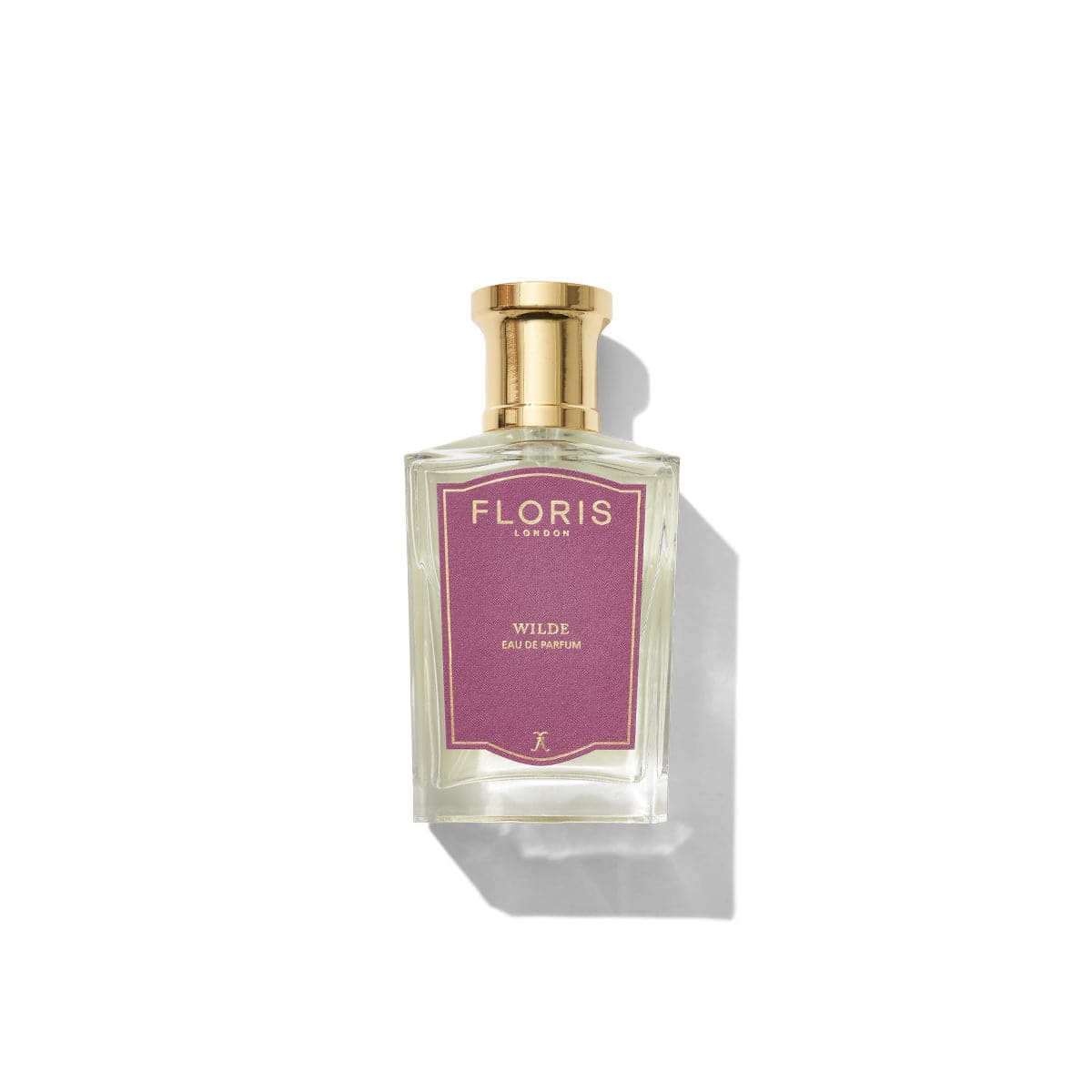 A bottle of Wilde - Eau de Parfum by Floris London, featuring a pink label and a gold cap, placed against a white background, exuding an air of individuality reminiscent of Oscar Wilde's unique style.