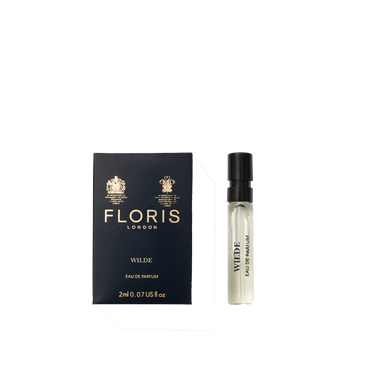 A Floris London Wilde - Eau de Parfum sample vial sits beside its navy blue box, embodying individuality and creative expression.