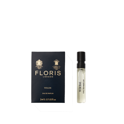A Floris London Wilde - Eau de Parfum sample vial sits beside its navy blue box, embodying individuality and creative expression.