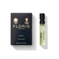A black Floris London Elite box and small perfume vial showcase a woody Elite fragrance with bergamot notes on a white background.