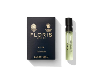 A black Floris London Elite box and small perfume vial showcase a woody Elite fragrance with bergamot notes on a white background.