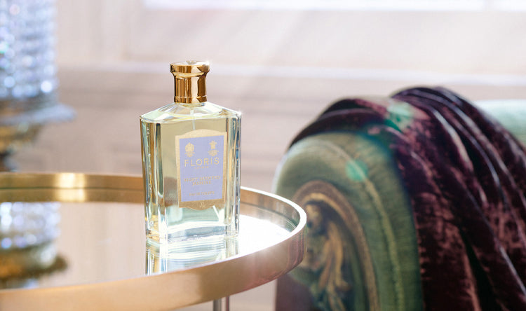 Night Scented Jasmine Eau de Toilette by Floris London US, showcased on a stylish circular table, with a cozy blanket in the background.