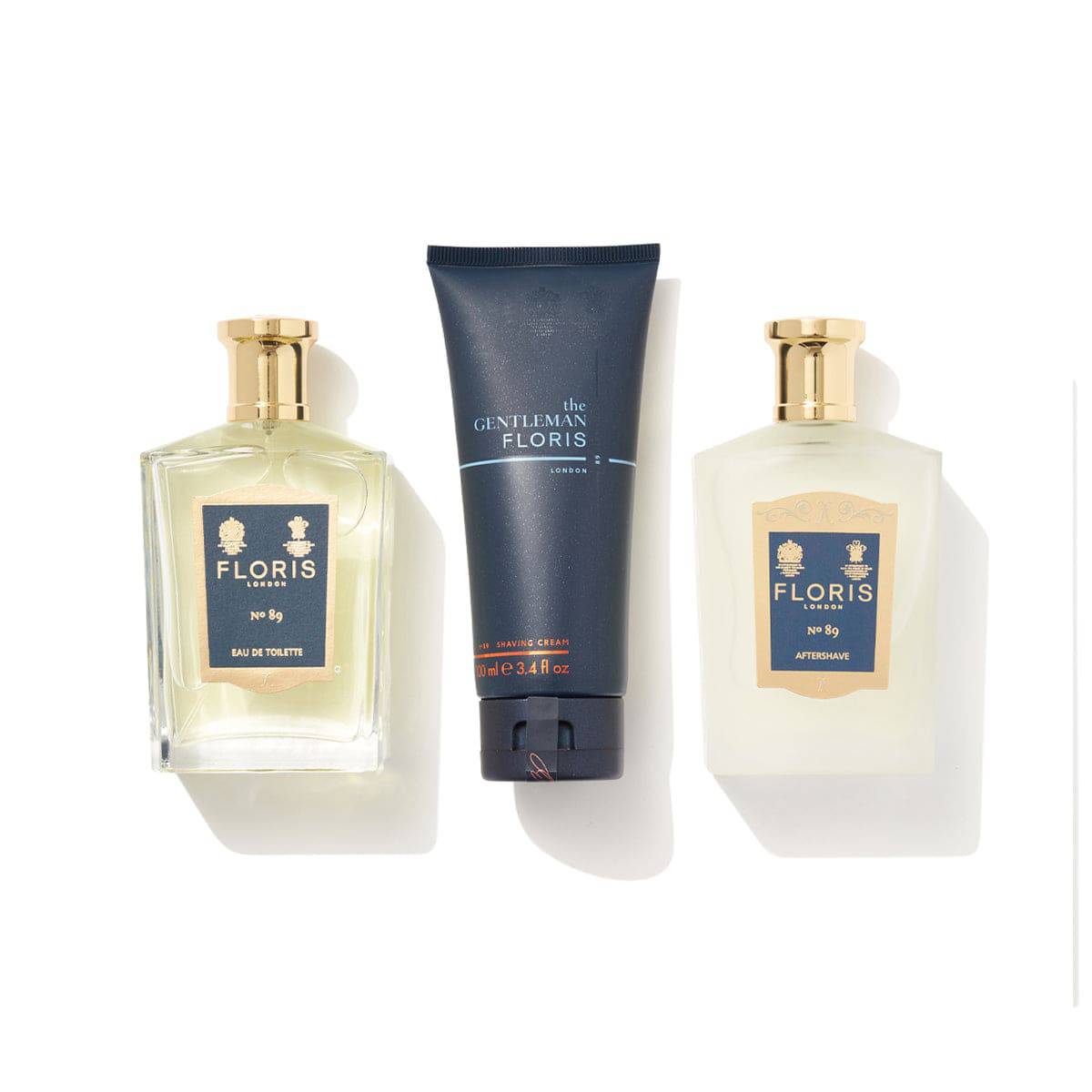 Three grooming products from Floris London’s No. 89 Collection—Eau de Toilette, Shaving Cream in a tube, and Aftershave—arranged on a white background. Invigorate your shaving routine with this signature fragrance ensemble.